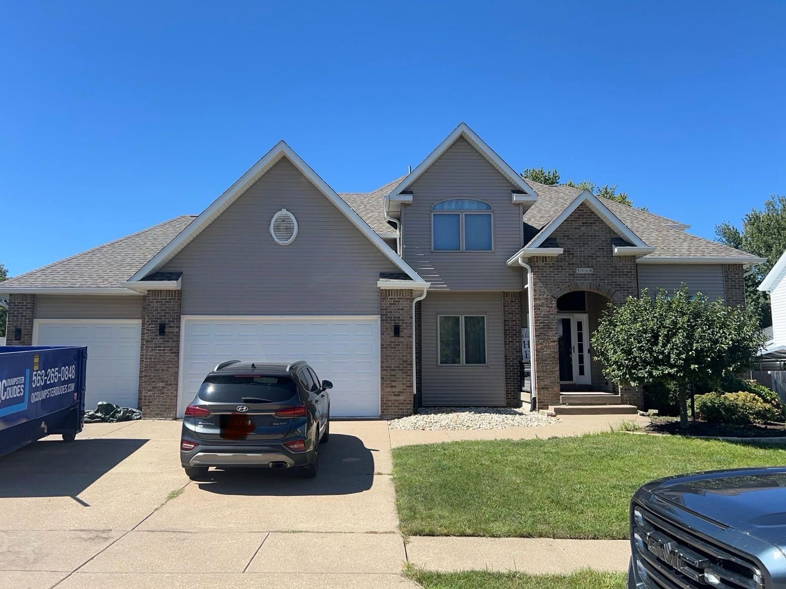 Two-story home with deck and driveway in Davenport, Iowa