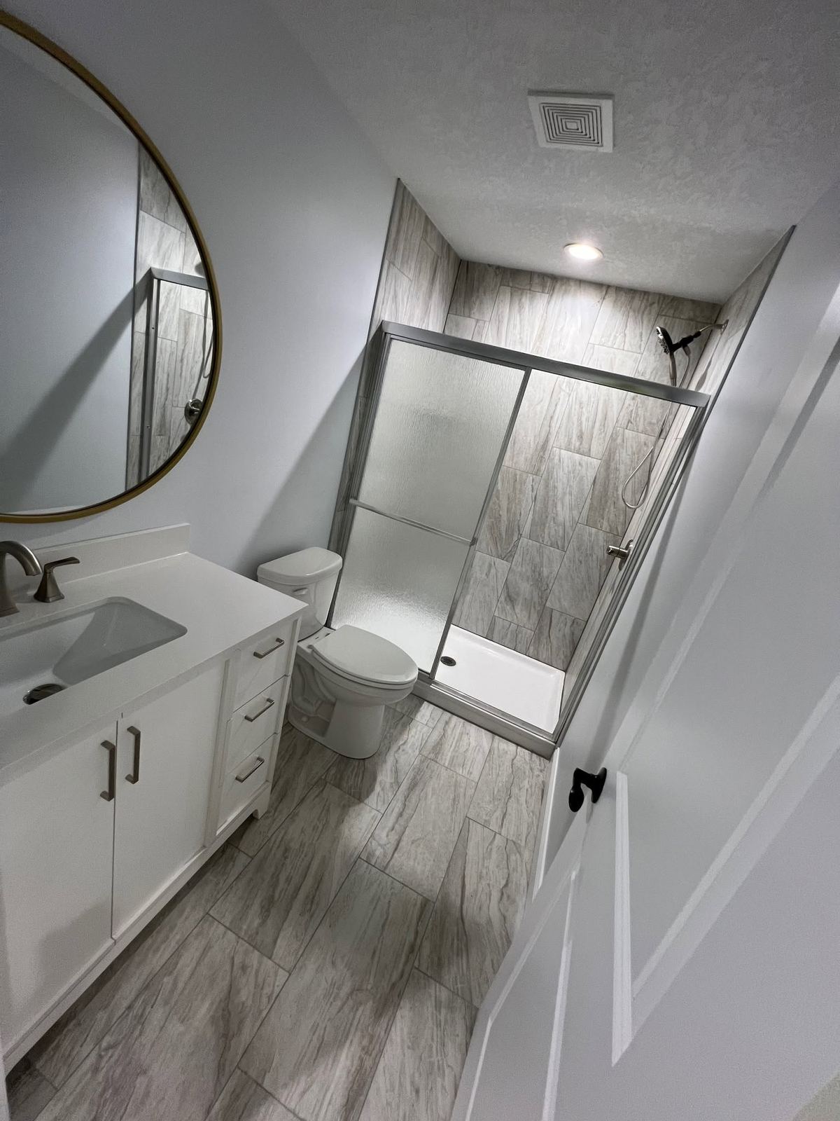 Gray tile shower frosted glass bathroom Davenport IA